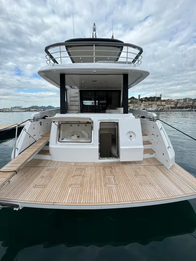  Yacht Photos Pics 2024 Azimut Fly 68 yacht with spacious deck and modern design, docked in a scenic harbor.