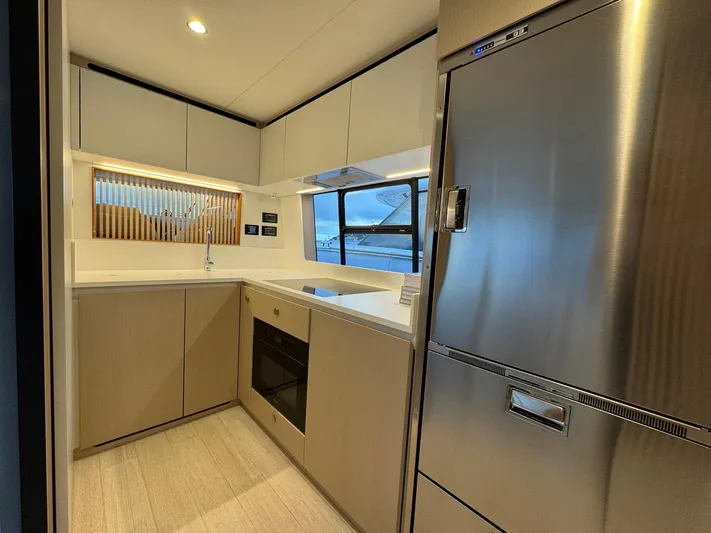  Yacht Photos Pics Modern kitchen interior of 2024 Azimut Fly 68 yacht with sleek appliances and cabinetry.