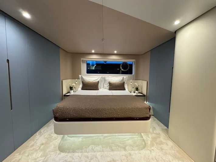  Yacht Photos Pics Luxurious bedroom interior of 2024 Azimut Fly 68 yacht, featuring modern design and ambient lighting.