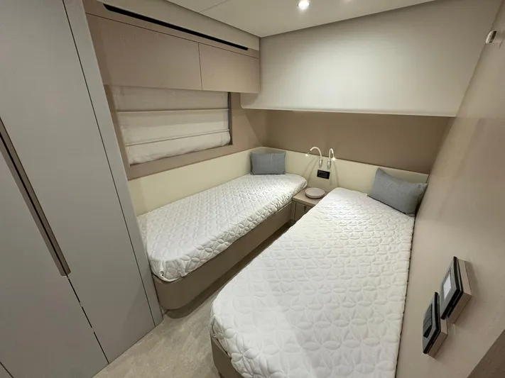  Yacht Photos Pics 2024 Azimut Fly 68 yacht cabin with twin beds, modern design, and soft lighting.