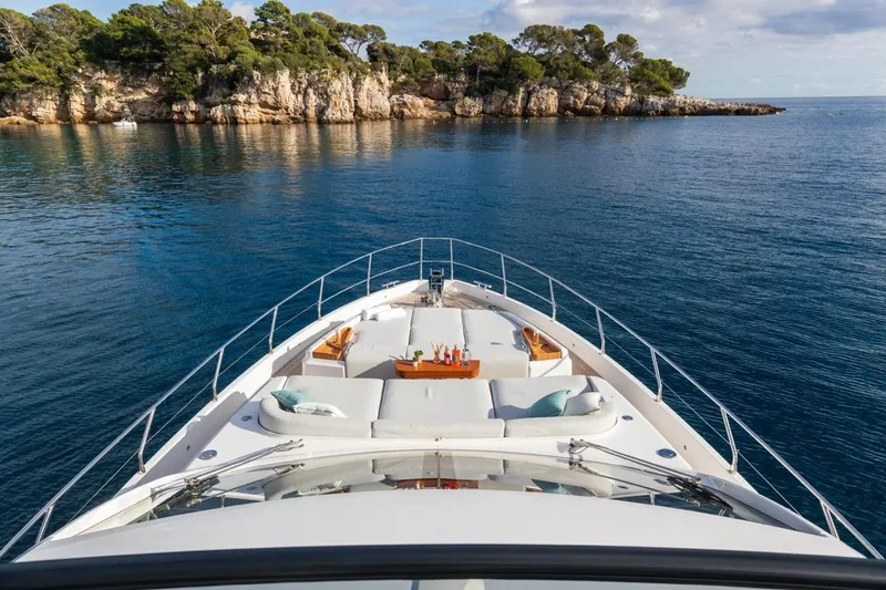  Yacht Photos Pics Luxurious 2024 Azimut Fly 68 yacht cruising near scenic rocky coastline.