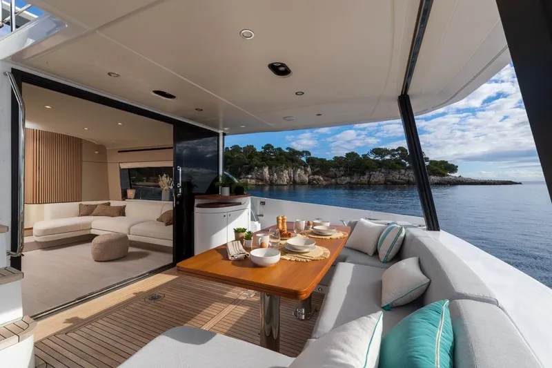  Yacht Photos Pics Luxurious 2024 Azimut Fly 68 yacht interior with elegant dining area and scenic ocean view.