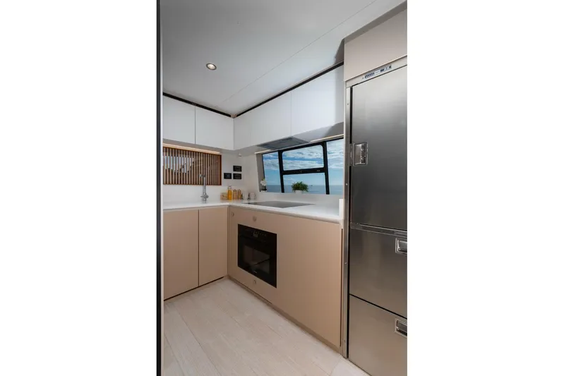  Yacht Photos Pics Modern kitchen interior of 2024 Azimut Fly 68 yacht, featuring sleek cabinetry and ocean view.