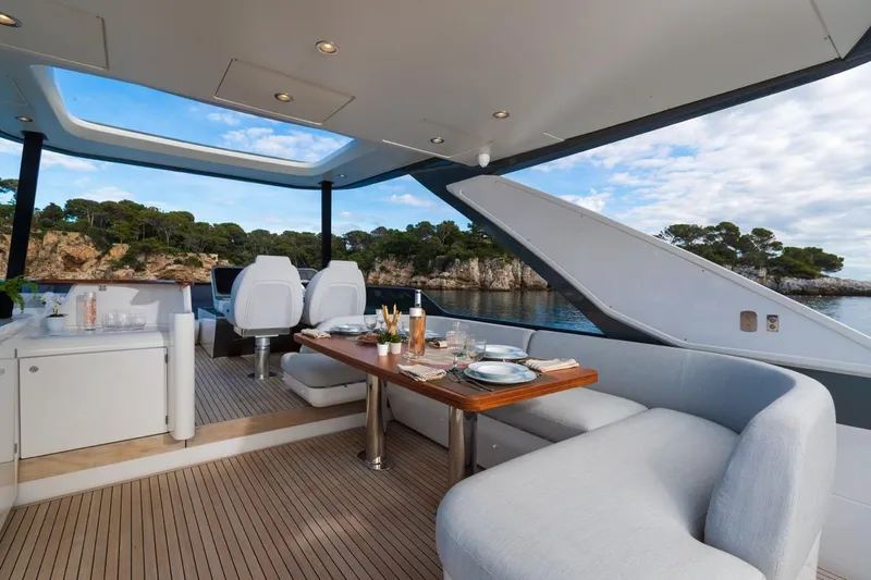  Yacht Photos Pics Luxurious 2024 Azimut Fly 68 yacht interior with elegant dining setup and scenic ocean view.