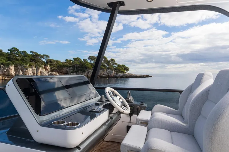  Yacht Photos Pics 2024 Azimut Fly 68 yacht helm with scenic ocean view and modern controls.