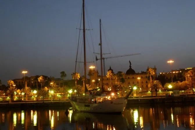  Yacht Photos Pics Sailboat docked at night with city lights reflecting on water, Custom Southern 1962.