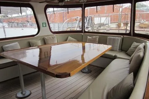  Yacht Photos Pics Luxurious 1962 Custom Southern yacht interior with polished wood table and cushioned seating.