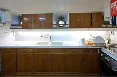  Yacht Photos Pics Vintage 1962 Custom Southern kitchen with wooden cabinets and dual sinks.