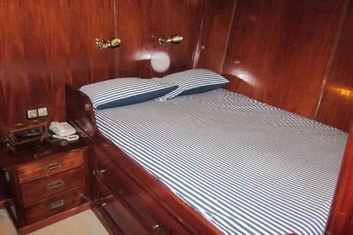  Yacht Photos Pics Vintage 1962 Custom Southern cabin with striped bedding and wooden furnishings.