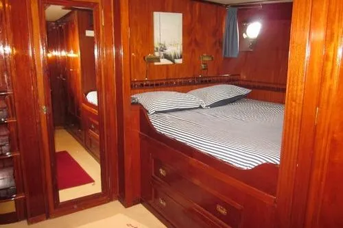  Yacht Photos Pics Luxurious 1962 Custom Southern yacht cabin with polished wood and striped bedding.