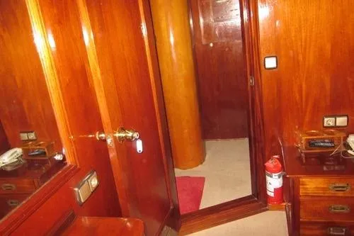  Yacht Photos Pics 1962 Custom Southern interior with wooden paneling, mirror, and fire extinguisher.