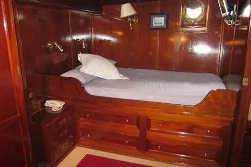 Yacht Photos Pics 1962 Custom Southern yacht cabin with wooden interior and single bed.