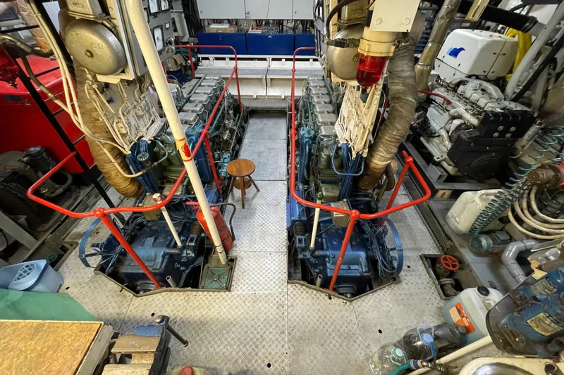  Yacht Photos Pics Engine room of a 1962 Custom Southern vessel, featuring dual engines and maintenance equipment.