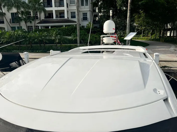  Yacht Photos Pics 2010 Beneteau Monte Carlo 47 yacht docked near residential buildings.