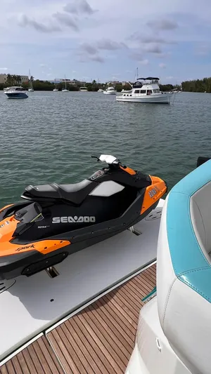  Yacht Photos Pics Orange Sea-Doo jet ski on a Beneteau Monte Carlo 47 yacht, 2010 model, in a scenic harbor.
