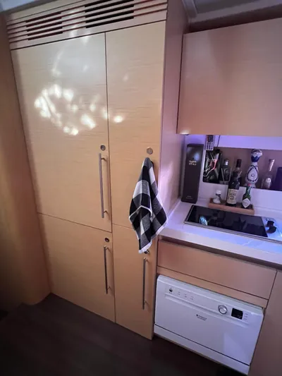  Yacht Photos Pics Modern kitchen interior of 2010 Beneteau Monte Carlo 47 yacht with wooden cabinets and appliances.