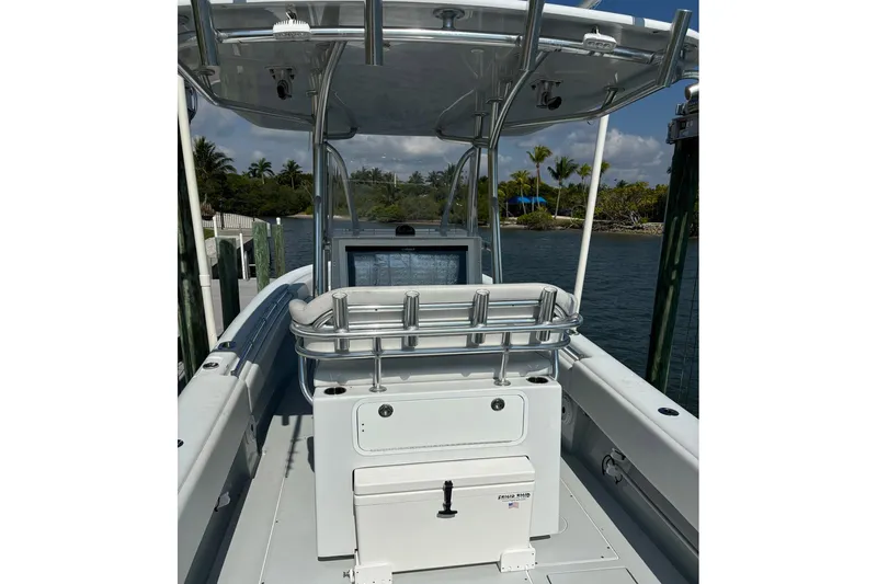  Yacht Photos Pics 2019 Contender 28 Sport boat interior with console and seating, docked by tropical shoreline.