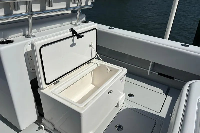  Yacht Photos Pics Open storage compartment on 2019 Contender 28 Sport boat, showcasing spacious interior.