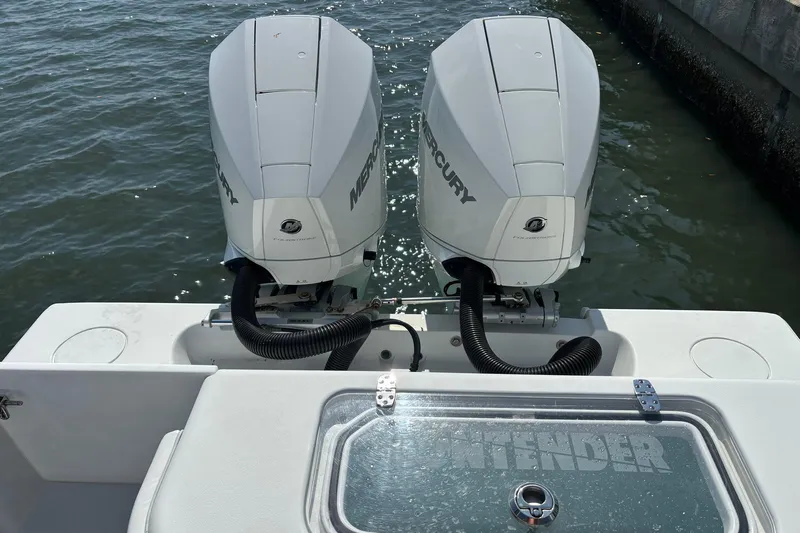  Yacht Photos Pics 2019 Contender 28 Sport boat with twin Mercury outboard engines on water.