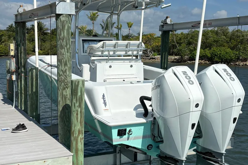  Yacht Photos Pics 2019 Contender 28 Sport boat with twin Mercury 200 engines on a lift.