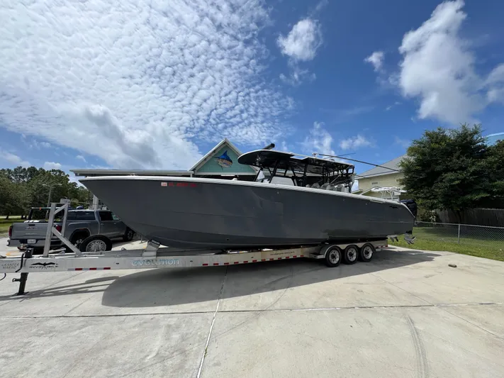  Yacht Photos Pics 2020 Invincible 40 Catamaran on trailer, parked outdoors under a partly cloudy sky.