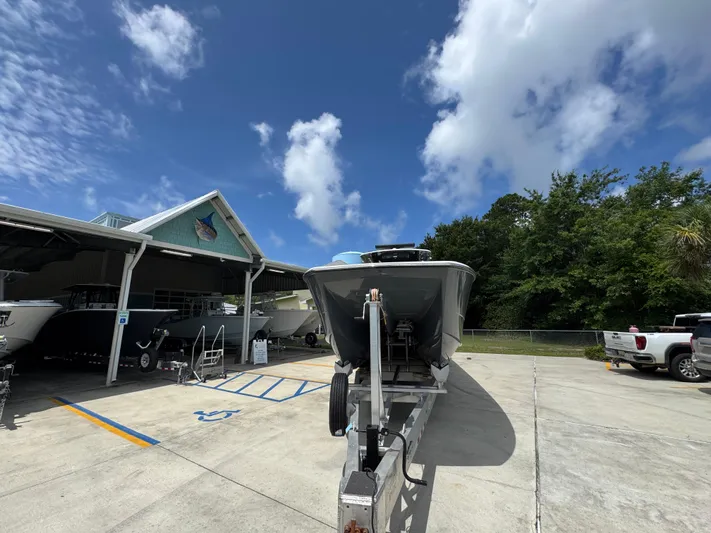  Yacht Photos Pics 2020 Invincible 40 Catamaran on trailer, parked outside under a clear blue sky.
