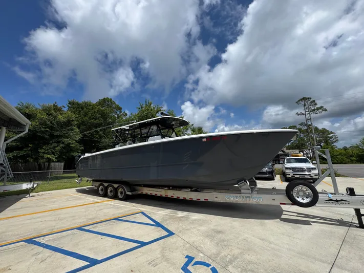  Yacht Photos Pics 2020 Invincible 40 Catamaran on trailer, parked outdoors under a partly cloudy sky.