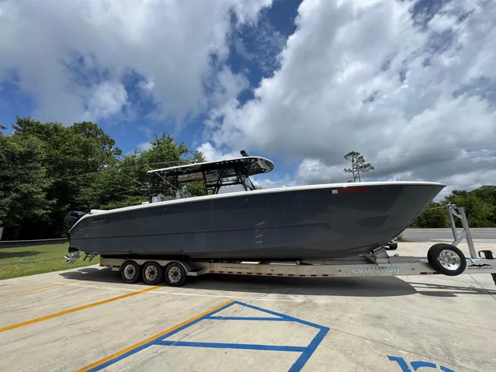  Yacht Photos Pics 2020 Invincible 40 Catamaran on trailer under cloudy sky.