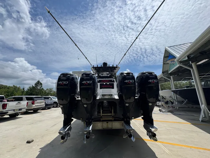  Yacht Photos Pics 2020 Invincible 40 Catamaran with four powerful 400 engines, docked under a partly cloudy sky.