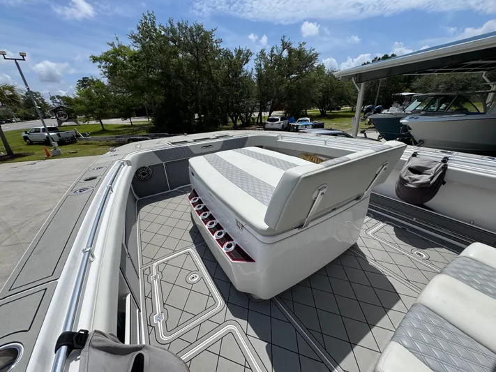  Yacht Photos Pics 2020 Invincible 40 Catamaran deck with seating, docked under a sunny sky.