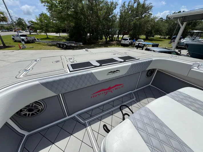  Yacht Photos Pics Invincible 40 Catamaran 2020 deck with seating and speaker, parked outdoors.