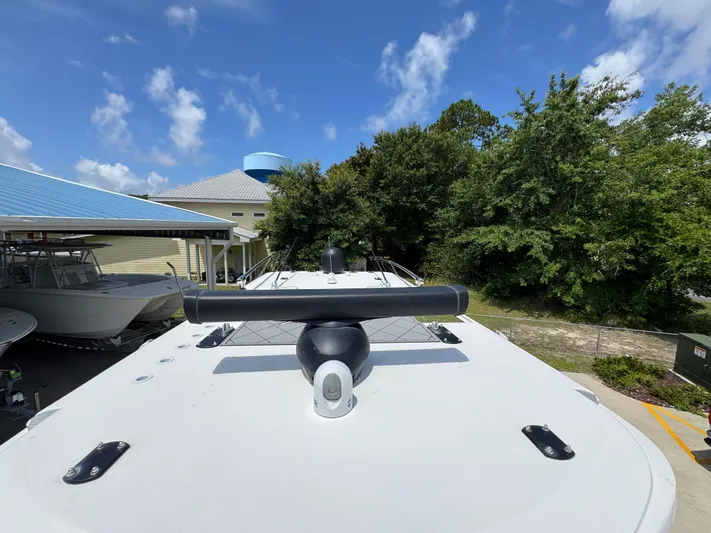  Yacht Photos Pics 2020 Invincible 40 Catamaran docked, showcasing sleek design and radar equipment under a clear sky.