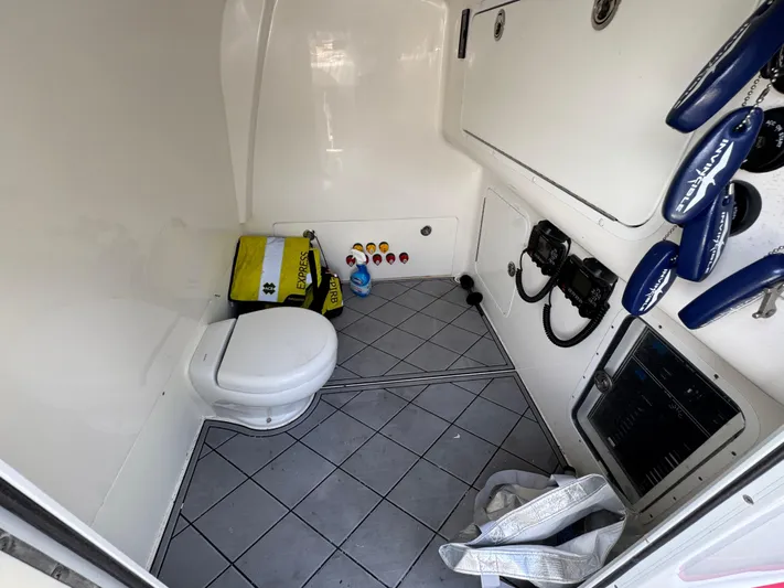  Yacht Photos Pics 2020 Invincible 40 Catamaran interior with toilet, safety gear, and control panel.