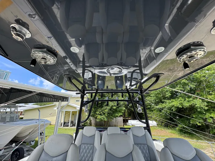  Yacht Photos Pics 2020 Invincible 40 Catamaran interior with sleek seating and overhead structure, docked outdoors.