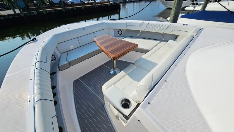  Yacht Photos Pics Luxurious seating area on 2021 Regal 38 SAV boat with elegant wooden table.