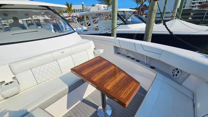  Yacht Photos Pics 2021 Regal 38 SAV yacht interior with elegant seating and wooden table.