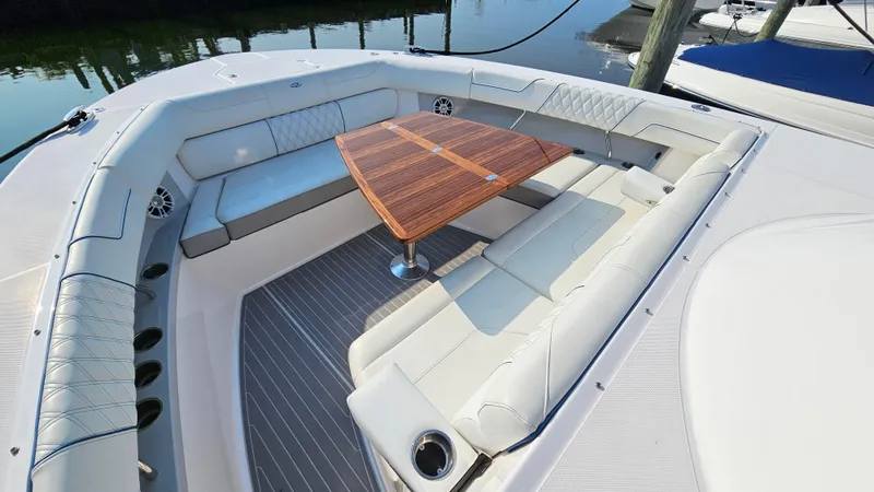  Yacht Photos Pics Luxurious seating area on 2021 Regal 38 SAV boat with wooden table.