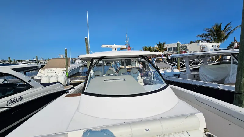  Yacht Photos Pics 2021 Regal 38 SAV boat docked at marina under clear blue sky.