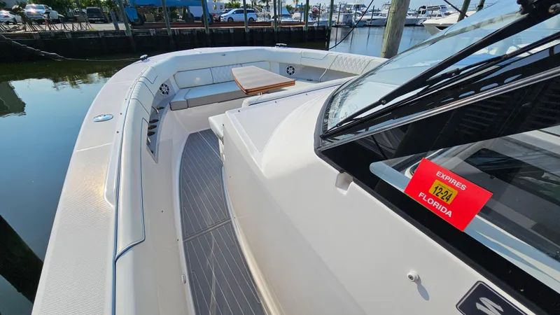  Yacht Photos Pics 2021 Regal 38 SAV boat docked, featuring spacious deck and seating area.