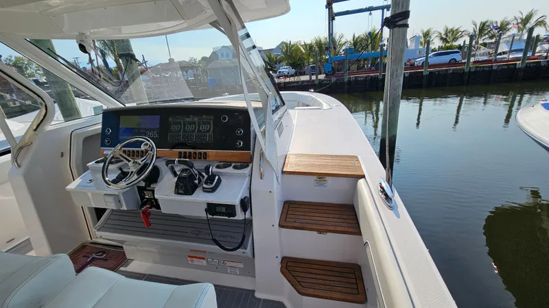  Yacht Photos Pics 2021 Regal 38 SAV boat helm with modern controls and waterfront view.