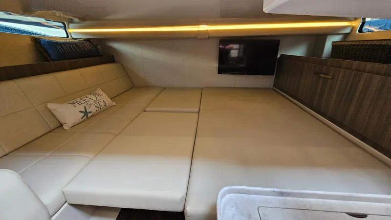 Yacht Photos Pics Interior cabin of 2021 Regal 38 SAV boat with beige seating and TV.