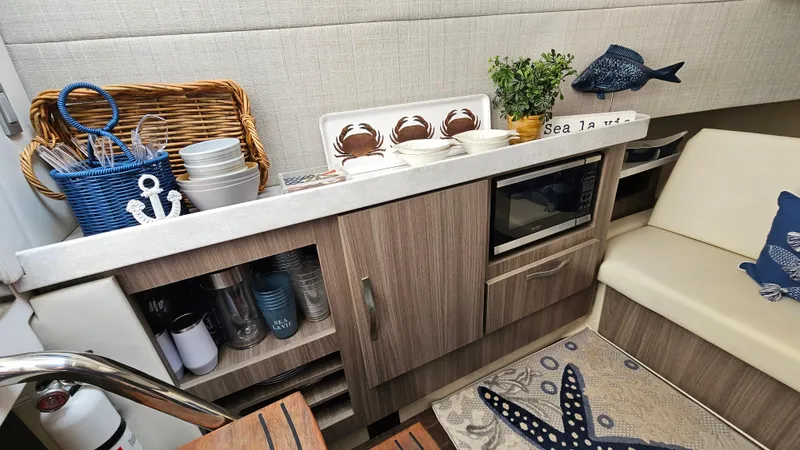  Yacht Photos Pics Cozy kitchen area in 2021 Regal 38 SAV boat with nautical decor and modern amenities.