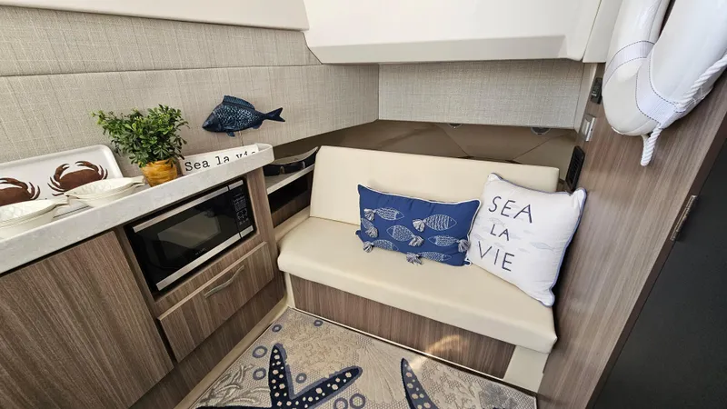  Yacht Photos Pics Cozy interior of 2021 Regal 38 SAV boat with nautical decor and seating area.