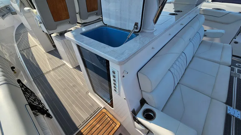  Yacht Photos Pics 2021 Regal 38 SAV boat interior with seating and kitchenette area.