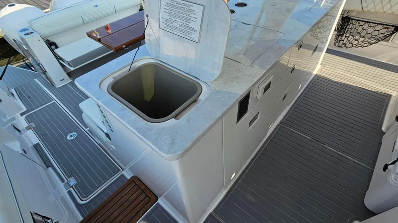  Yacht Photos Pics 2021 Regal 38 SAV yacht deck with built-in storage and seating area.