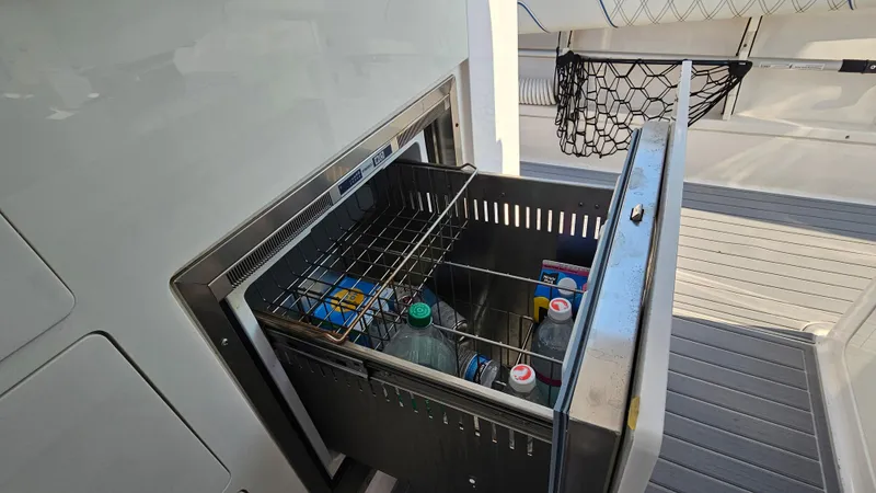  Yacht Photos Pics Built-in cooler on 2021 Regal 38 SAV yacht, stocked with beverages and snacks.