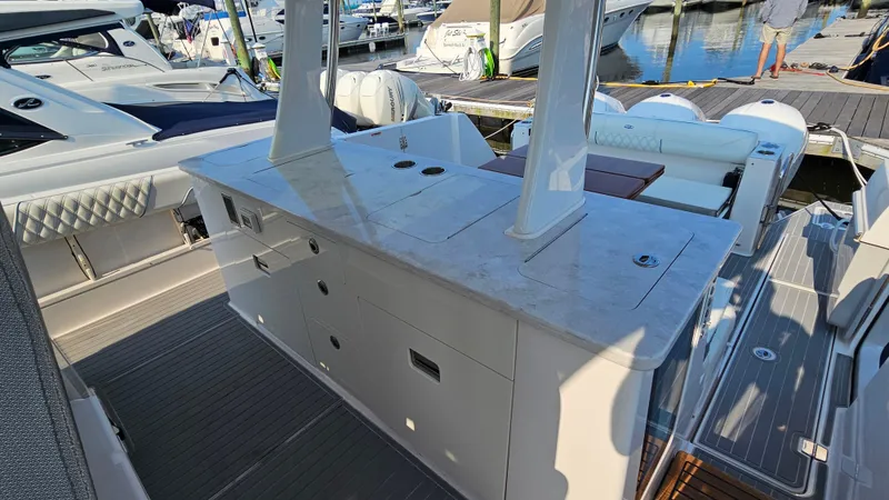  Yacht Photos Pics 2021 Regal 38 SAV boat interior with sleek countertops and seating at a marina.