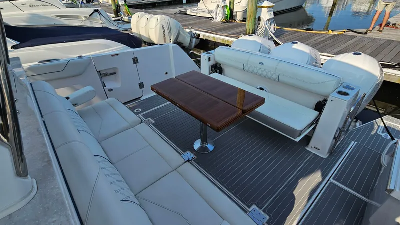  Yacht Photos Pics Luxurious 2021 Regal 38 SAV boat interior with elegant seating and wooden table.