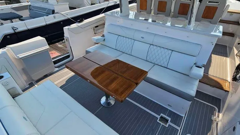  Yacht Photos Pics 2021 Regal 38 SAV yacht interior with elegant seating and wooden table.