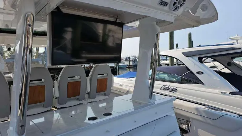  Yacht Photos Pics 2021 Regal 38 SAV boat interior with seating and mounted TV display.